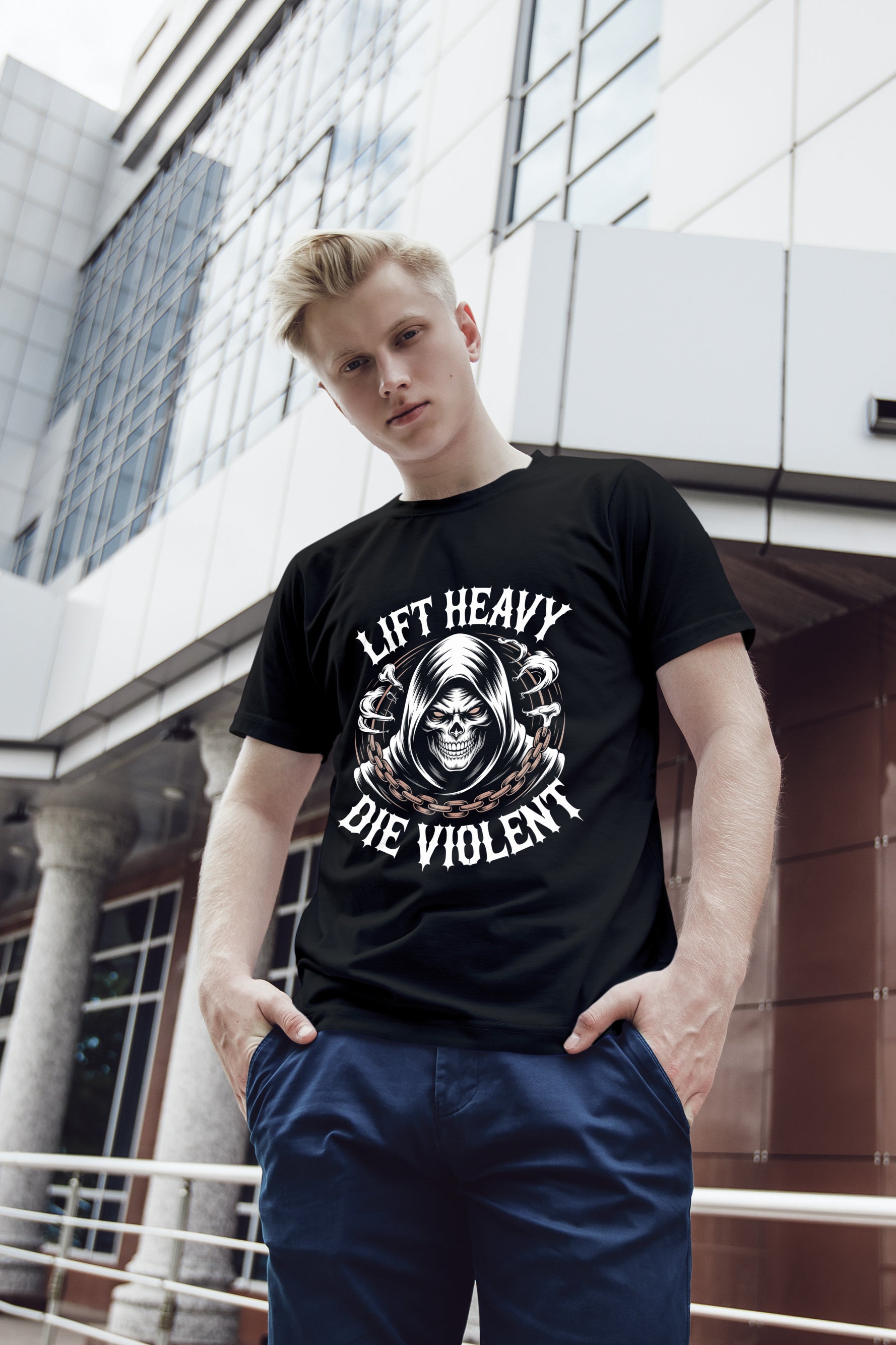 Person wearing a black metal gym t-shirt with a graphic design and text 'lift heavy die violent', standing in front of a modern building.